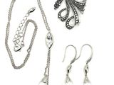 a necklace, earring, and bracelet set on a white background