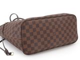 a brown and black checkered toilet bag on a white background