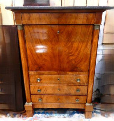 a wooden cabinet that has a marble top on it