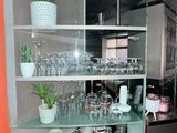 a glass shelf with a lot of wine glasses on it