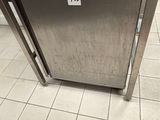 a stainless steel oven sitting on the floor in a kitchen