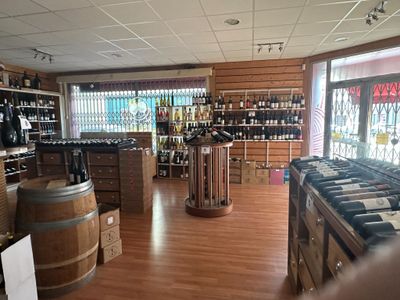 bottles of wine are lined up on the shelves in a wine shop