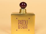 an image of a bottle of perfume sitting on top of a table