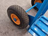a blue hand truck with two orange wheels on it