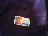 a close up of a purple jacket with a logo on it