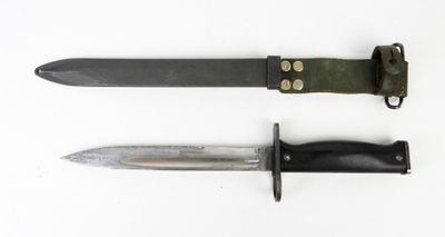 two different types of knives on a white surface