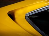 a close up of a yellow car with the hood up