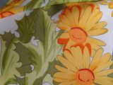 a close up of a yellow and orange flowered scarf