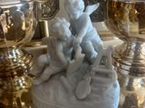 a statue of a boy and a girl sitting on a table