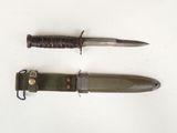 two knives that are laying next to each other on a table
