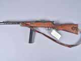 an old rifle with a wooden handle on a white surface