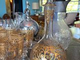 bottles and glasses on a table in a room with blue walls