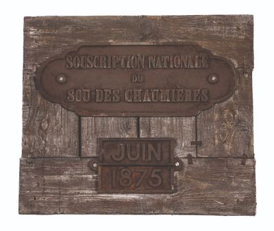 a plaque on the wall of a building with a name on it
