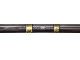 a close up of a wooden stick with a metal handle