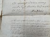 an old document with writing on it sitting on a table