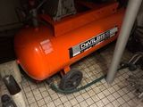 an orange air compressor under a kitchen counter