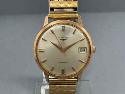 an image of a gold wrist watch on a clear stand