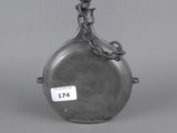a silver flask with a bird on the top of it