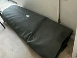 a mattress that is laying on the floor in the corner of a room