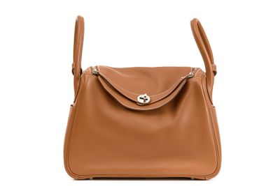 a brown leather shoulder bag with a metal clasp