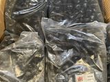 many bags of black stuff in a cardboard box