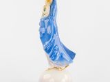 figurine of a woman in a blue dress on a white base