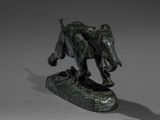 statue of an elephant on a rock with a shadow on a gray background