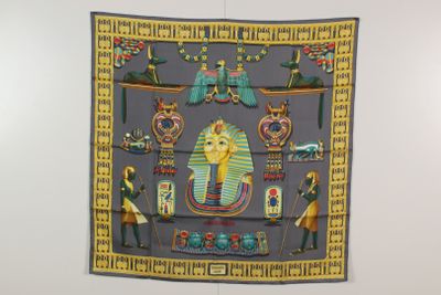 une écharpe accrochée au mur, sur laquelle figure l'image d'un pharaon