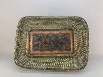an antique brass plate with a picture of a man and a woman
