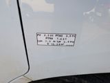 a sticker on the side of a white car