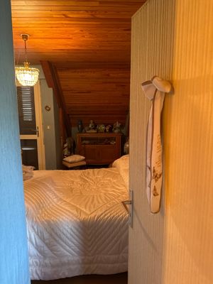 un lit blanc dans une chambre au plafond en bois