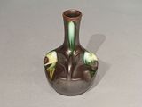 a small vase with a green and yellow design on it