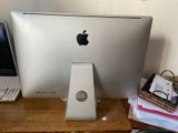 an apple computer sitting on a desk next to a laptop