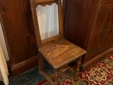une chaise en bois posée devant une armoire en bois