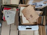a box full of books and papers on the floor