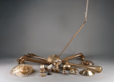 a lot of brass objects that are on a table