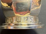 a close up of a silver plate with a cup on it