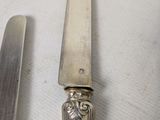 a knife and a knife holder sitting on a table