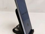 a phone that is sitting on a stand on the table