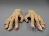 pair of fake hands on a table with a gray background