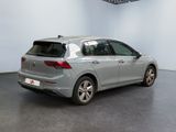 the back of a silver volkswagen golf parked in a large room
