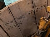 a picture of a wooden spool with a blue towel on it