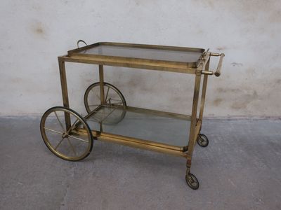 brass bar cart with glass shelves and wheels