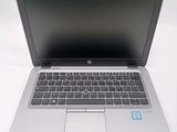 an open laptop computer sitting on top of a white table