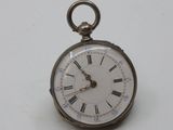a silver pocket watch with roman numerals on the face