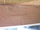 a close up of a piece of wood with writing on it