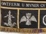 a black banner with gold fringes on a white background