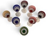 several different colored vases are arranged in a circle on a white surface