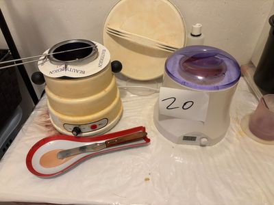 a table with a blender, a cup, a spoon, and other items on it