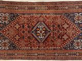 an antique persian rug with a geometric design